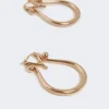 Monogram earrings in metal, gold